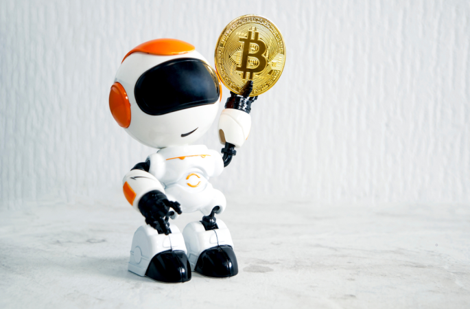 the robot holds a gold bitcoin in its hand